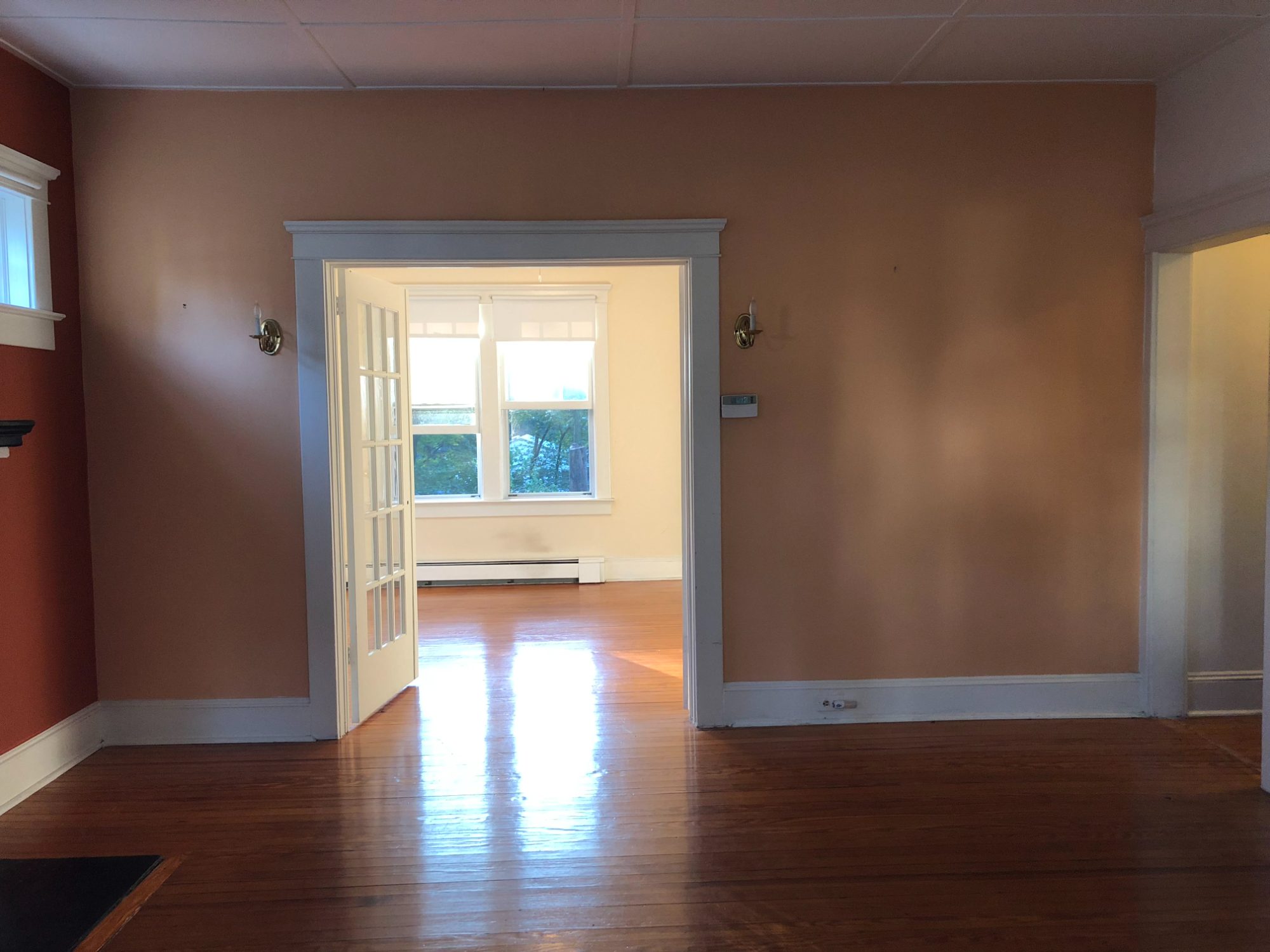The same rooms as bought, with salmon walls and the original French doors.